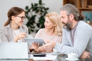 mature couple listening to agent making presentati ZSFXB8N